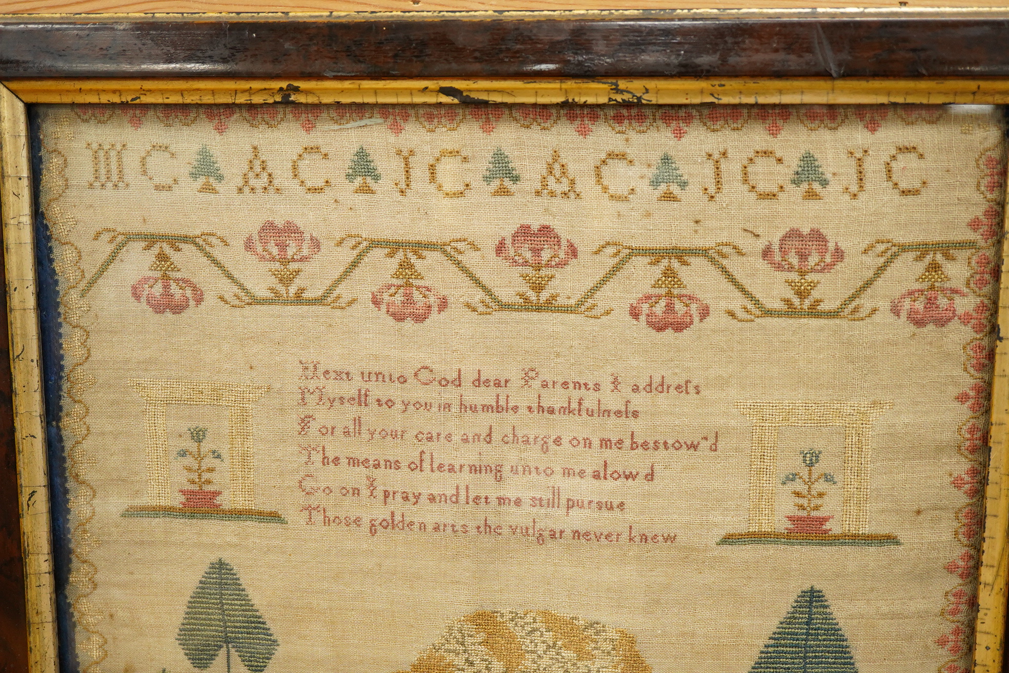 An early 19th century framed sampler by Sarah Crowhurst aged 10 years, dated 1811. Very finely embroidered, on fine linen, with a line of alphabet, then a religious verse and a large central spaniel motif between stylist